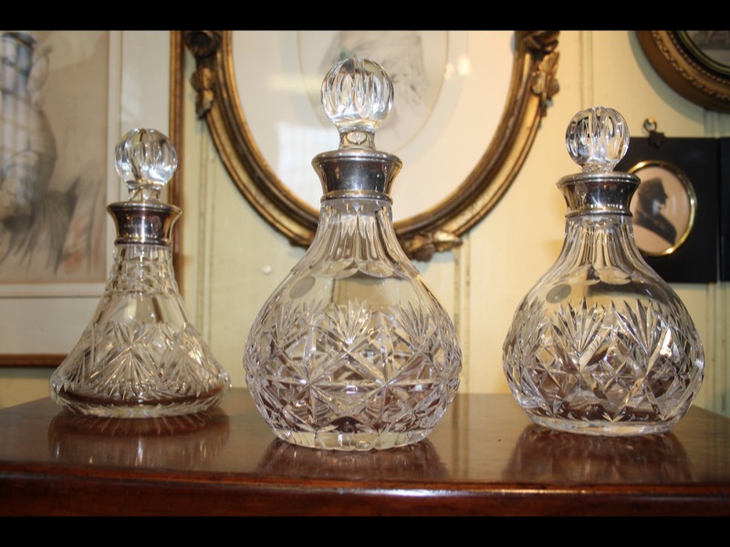 Three cut glass decanters