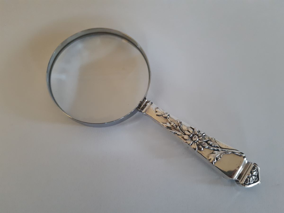 Silver flower magnifying glass